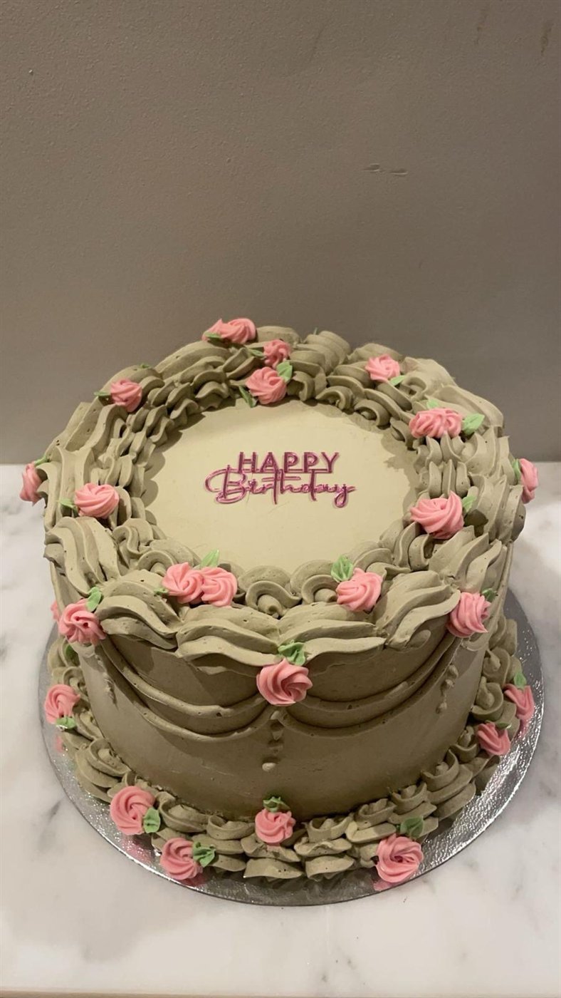 Vintage birthday cake with pink piped roses