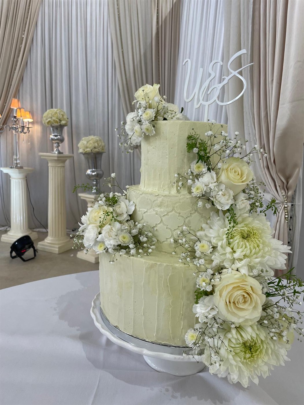 Three tier white floral wedding cake